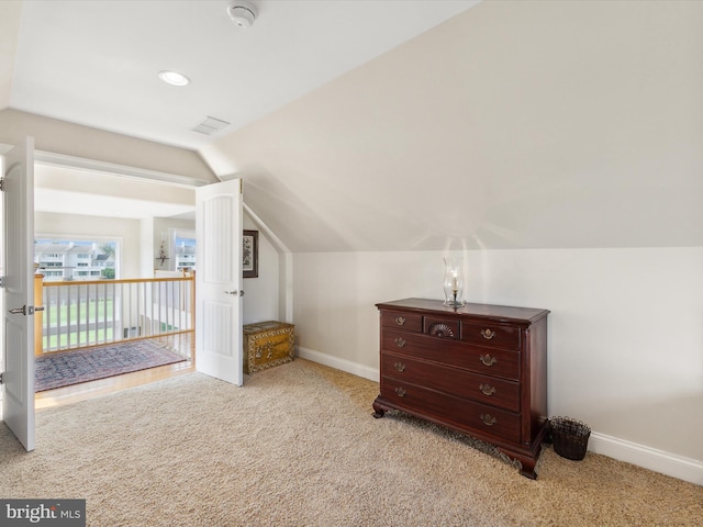 bonus room featuring light colored carpet and vaulted ceiling