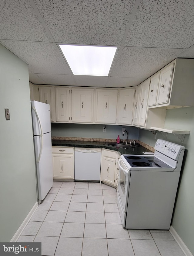 kitchen featuring sink, white appliances, light tile patterned floors, white cabinetry, and a drop ceiling