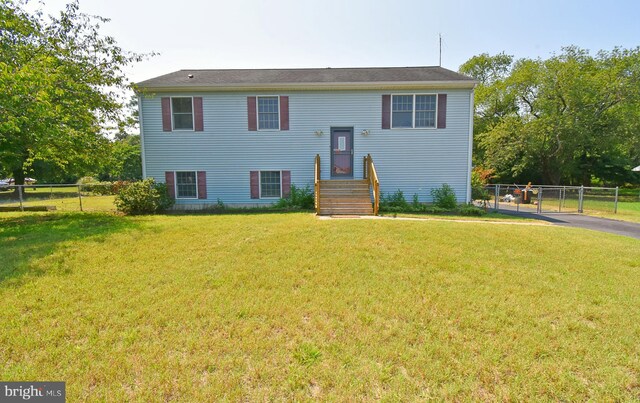 bi-level home with a front lawn