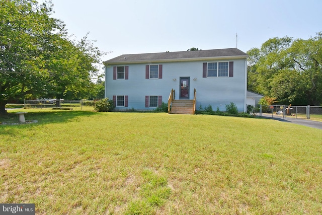 back of house featuring a lawn