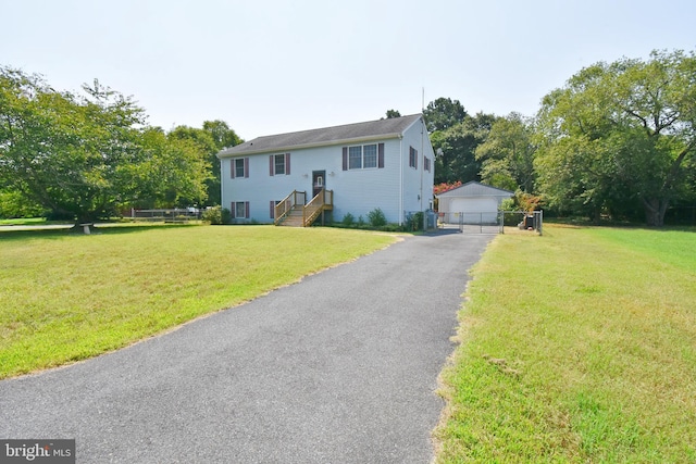 split foyer home with an outbuilding, a garage, and a front yard