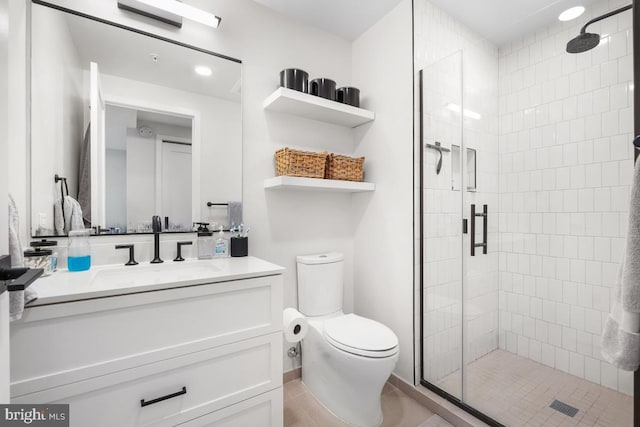 bathroom featuring vanity, tile patterned flooring, a shower with shower door, and toilet