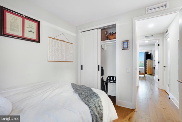 bedroom featuring light hardwood / wood-style flooring and a closet