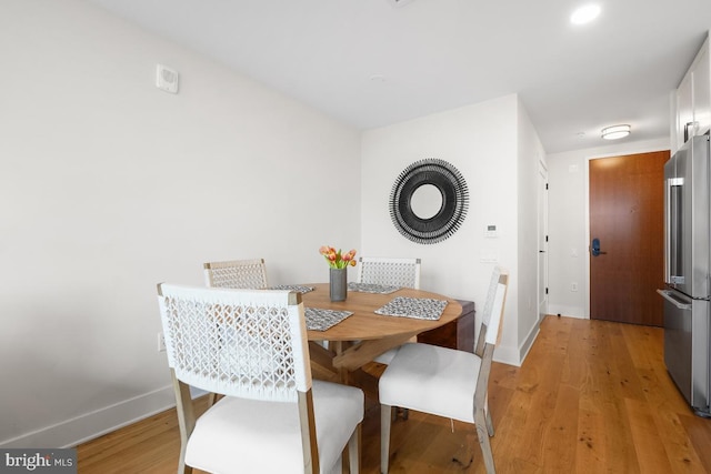 dining room with hardwood / wood-style flooring