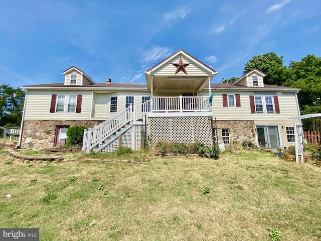 back of property featuring a yard