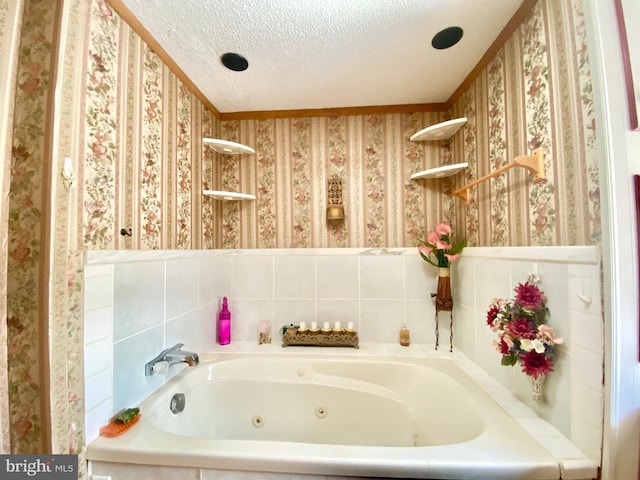 bathroom with a tub and a textured ceiling