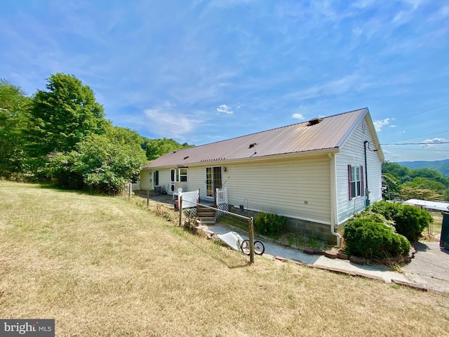 rear view of property featuring a yard