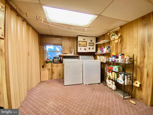 laundry area with independent washer and dryer, carpet flooring, and wood walls