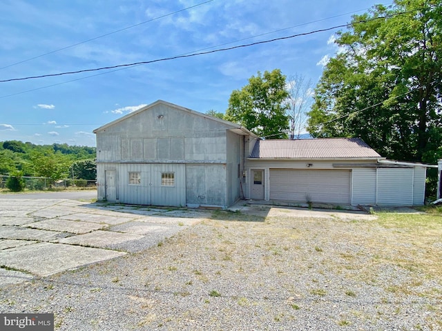 view of front of home featuring a garage and an outdoor structure