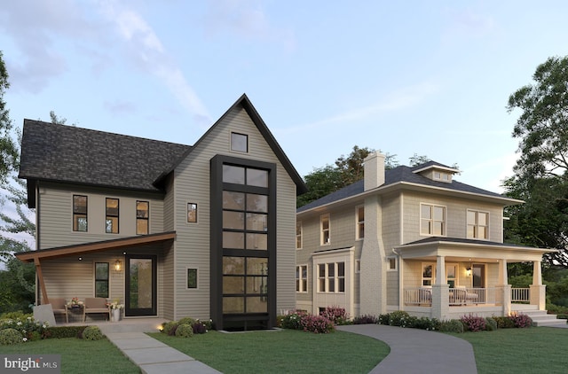 view of front of home with covered porch and a front yard