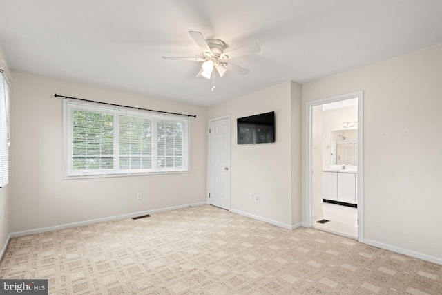 carpeted spare room featuring ceiling fan