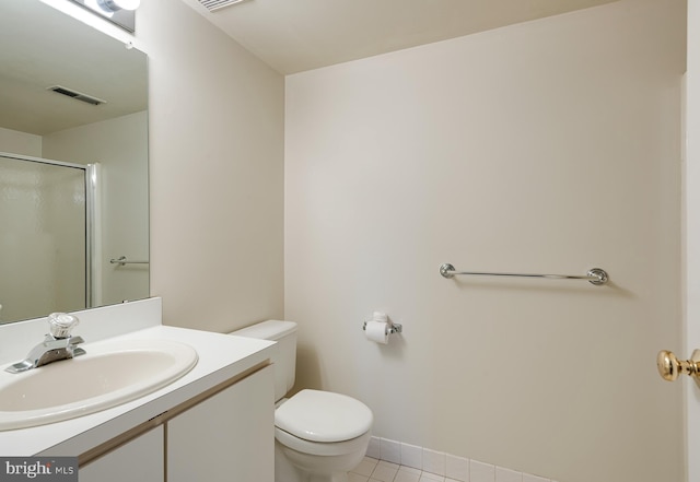 bathroom with tile patterned flooring, toilet, and vanity