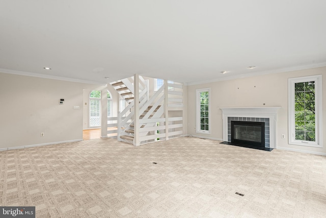 unfurnished living room featuring crown molding, light carpet, and a healthy amount of sunlight