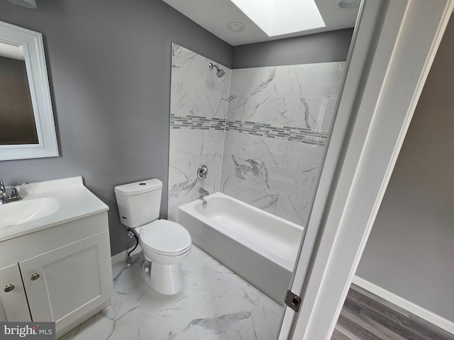 full bathroom with tiled shower / bath, toilet, vanity, and a skylight