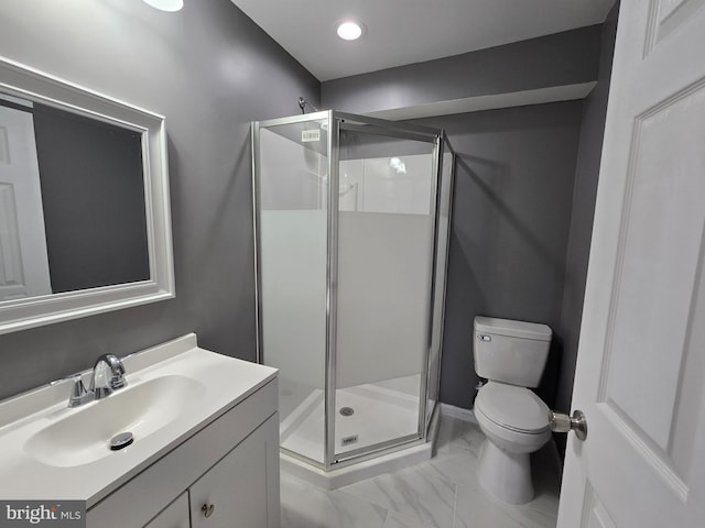 bathroom featuring vanity, toilet, and an enclosed shower