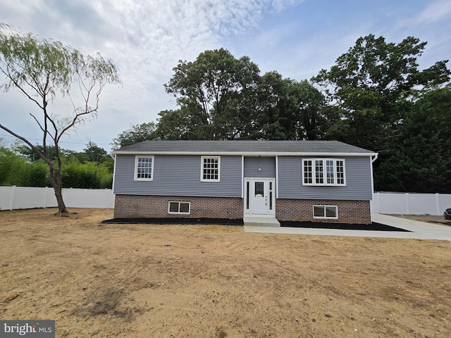 split foyer home with a front lawn