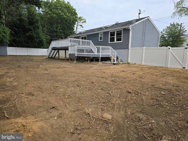 back of property with a wooden deck