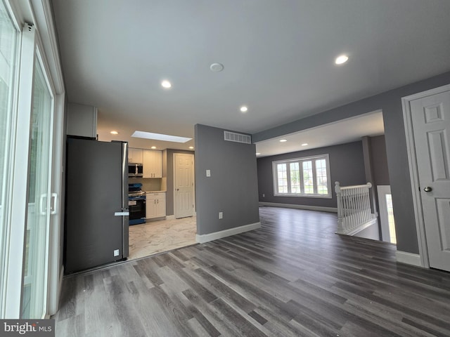 unfurnished living room with hardwood / wood-style flooring