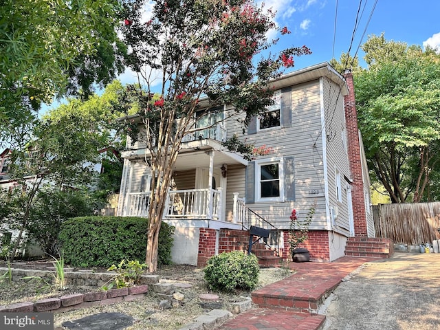 view of front facade featuring a balcony and covered porch