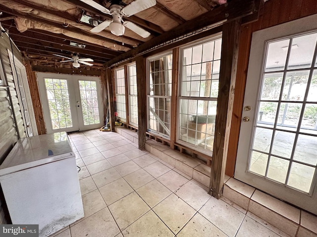 unfurnished sunroom with ceiling fan