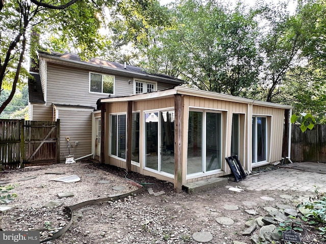 back of property with a sunroom