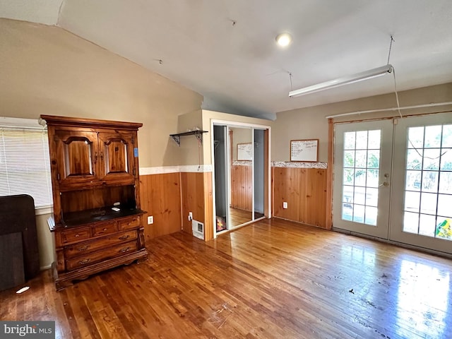 interior space with french doors, vaulted ceiling, and light wood-type flooring