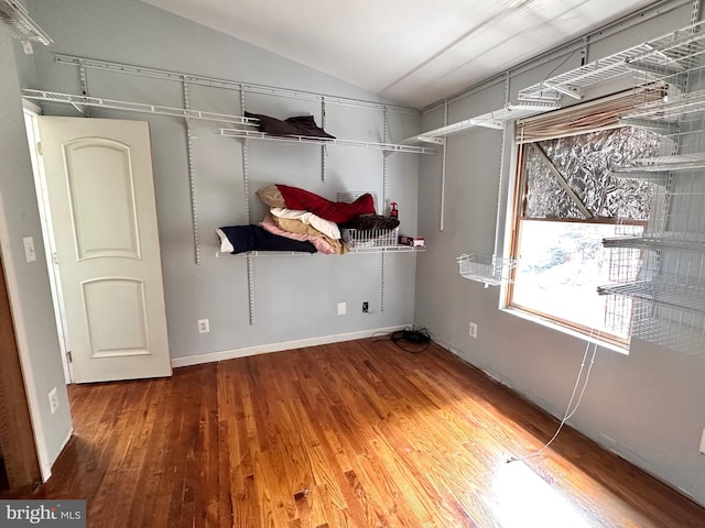 walk in closet featuring lofted ceiling and hardwood / wood-style floors