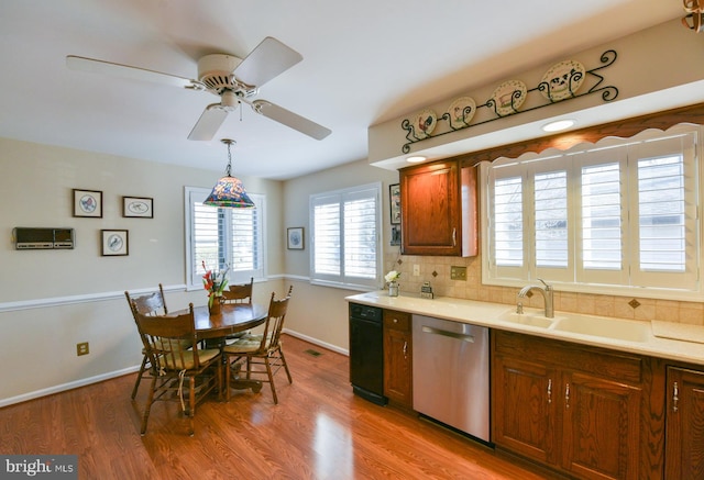 kitchen featuring pendant lighting, light hardwood / wood-style flooring, sink, ceiling fan, and stainless steel dishwasher