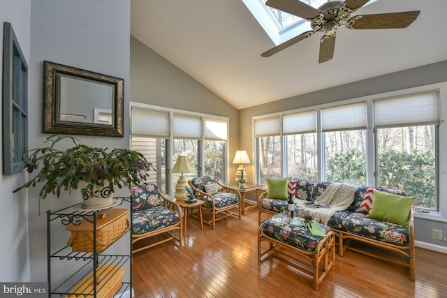 sunroom / solarium with ceiling fan, a wealth of natural light, and lofted ceiling with skylight