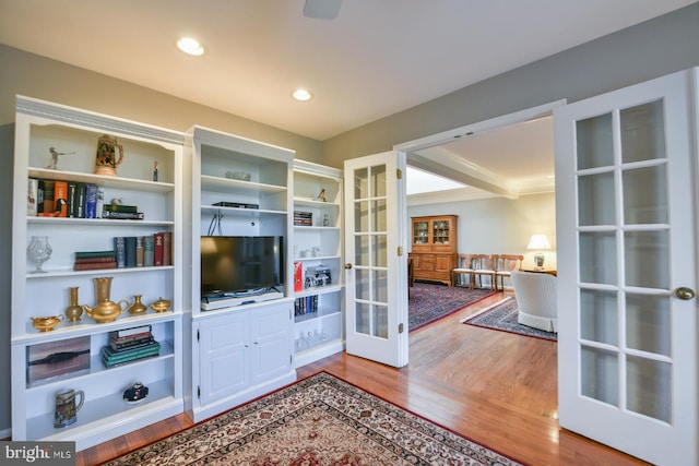 living room featuring hardwood / wood-style flooring, beamed ceiling, and french doors