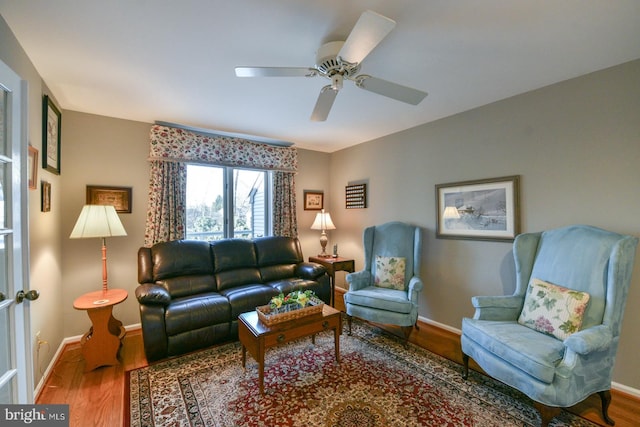 living room featuring ceiling fan and hardwood / wood-style floors