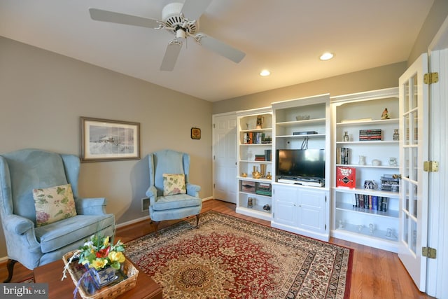 living room with ceiling fan and hardwood / wood-style floors