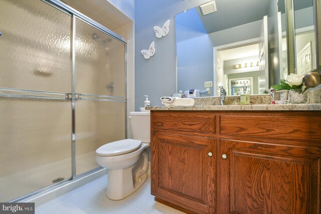 bathroom with tile patterned floors, walk in shower, toilet, and vanity