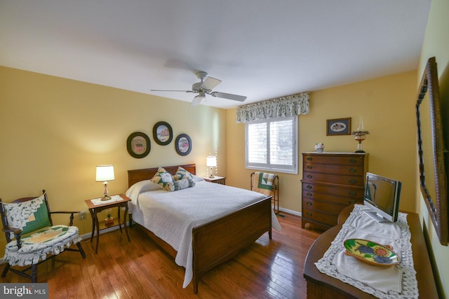 bedroom with ceiling fan and dark hardwood / wood-style floors