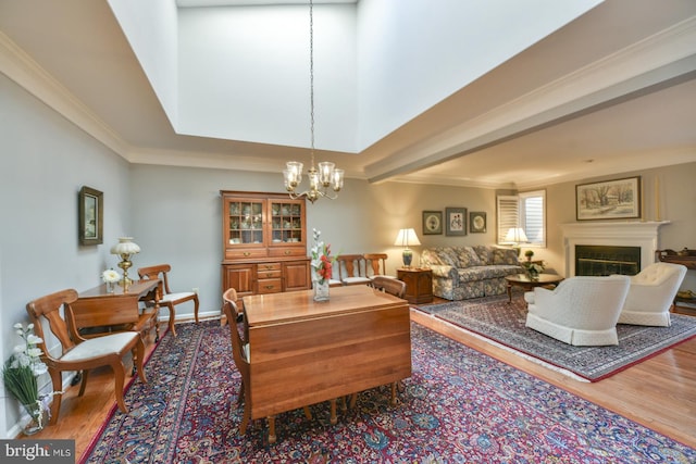 interior space with crown molding, wood-type flooring, and an inviting chandelier