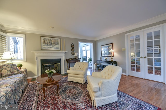 living room with ornamental molding, french doors, and hardwood / wood-style flooring