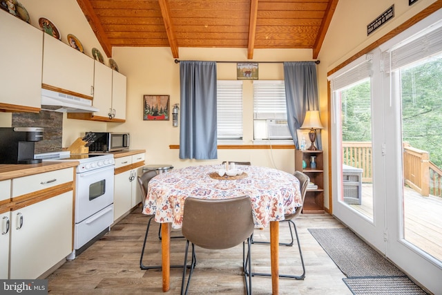 kitchen featuring lofted ceiling with beams, light wood-type flooring, wooden ceiling, and white gas range