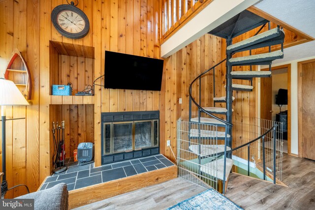 living room with wood-type flooring and wood walls