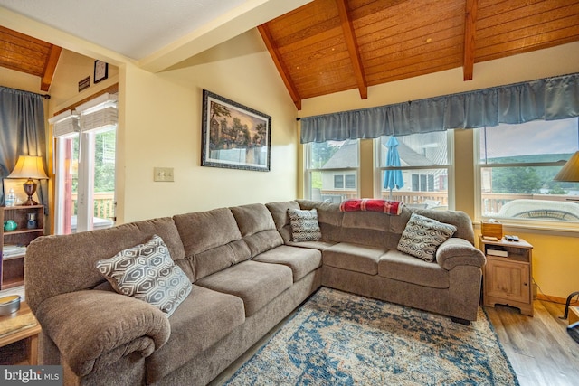 living room featuring light hardwood / wood-style floors, vaulted ceiling with beams, and wood ceiling