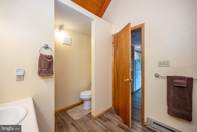 bathroom featuring a baseboard radiator, vanity, wood-type flooring, and toilet