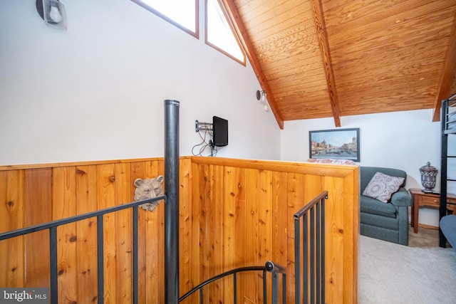 interior space featuring carpet flooring, vaulted ceiling with beams, and wood ceiling