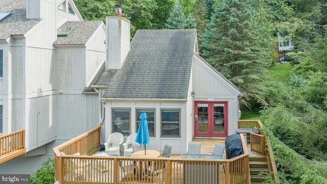 back of property with a deck and french doors