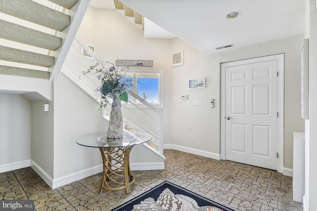 entryway featuring stairs, visible vents, and baseboards