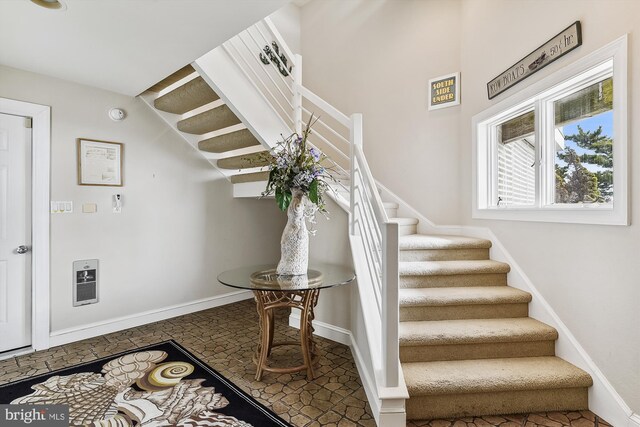 staircase featuring tile patterned floors