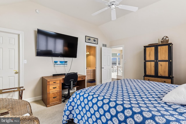 bedroom with ceiling fan, light carpet, vaulted ceiling, and connected bathroom