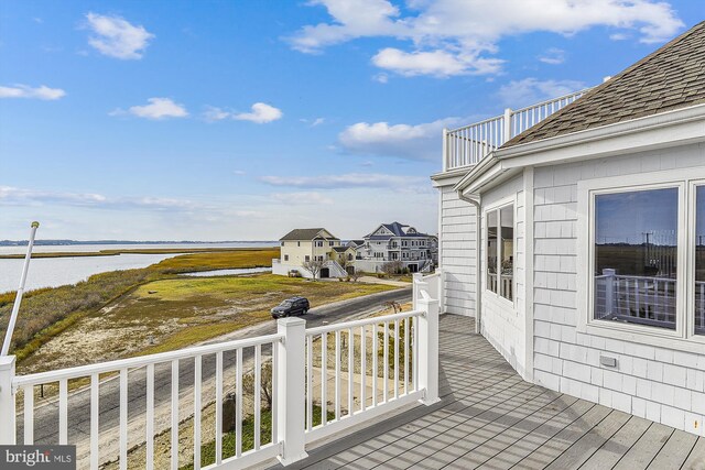 wooden terrace featuring a water view