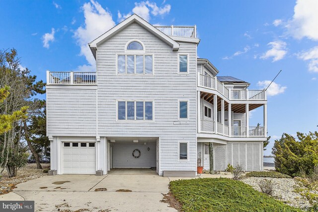 view of front of home featuring a balcony and a garage