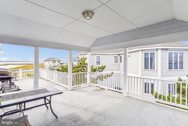 sunroom / solarium featuring vaulted ceiling