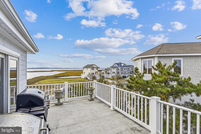 balcony featuring a water view