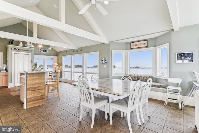 dining area with high vaulted ceiling, beam ceiling, a water view, ceiling fan, and light tile patterned floors